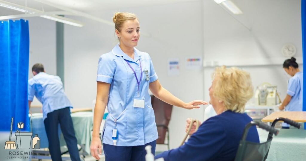 Nurse discussing hospital discharge home preparation with an elderly patient in a wheelchair